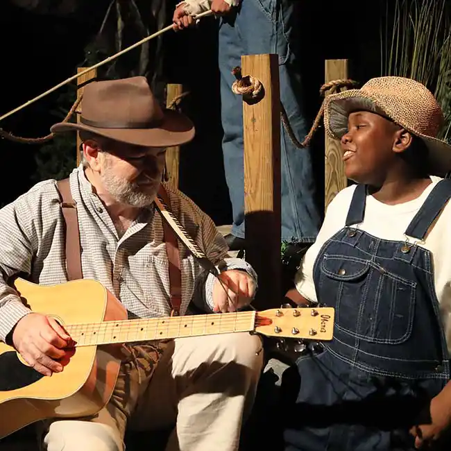 man and boy with guitar