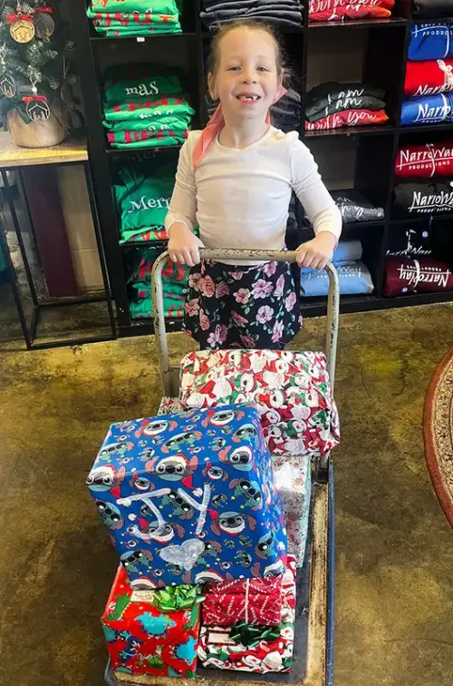 child with gifts on cart