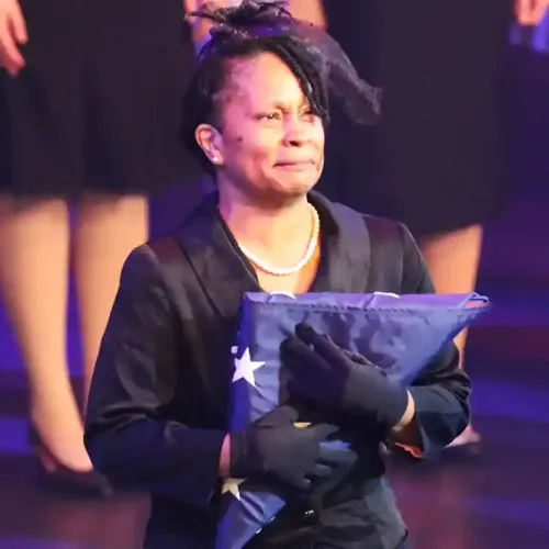 mother holding folded flag